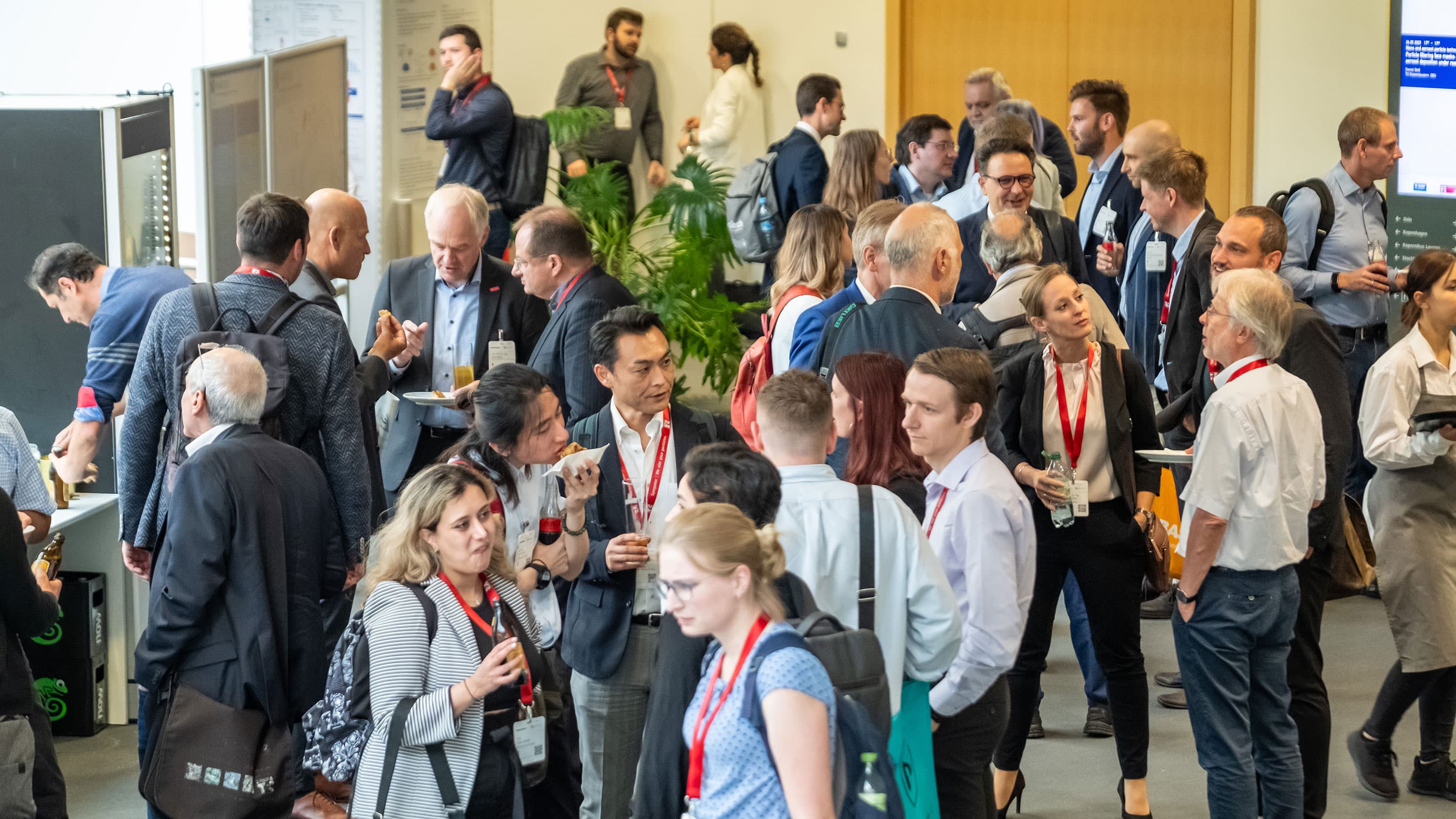 A crowd of people networking in smaller groups